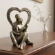 Candlelight Resin Couple Sat Down Holding Heart Ornament - Bronze