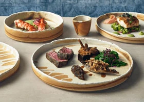 Professional table setting showcasing ceramic serving dishes and platters for communal Kenyan dining