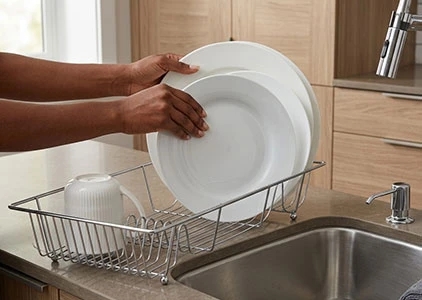 Organised kitchen sink area with dish drainer and sink tidy in Kenya